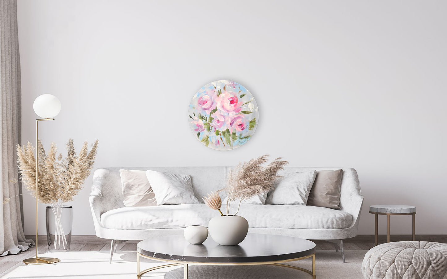 Living room with a floral wall art piece above a white sofa.