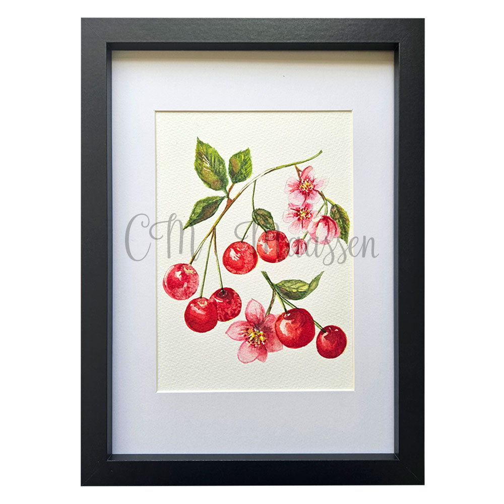 Framed artwork of cherries and flowers with a black frame on a white background