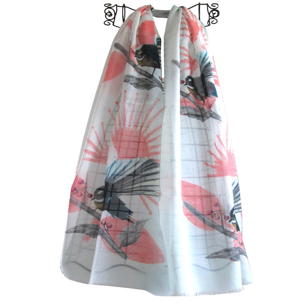 A white cotton scarf with pink designs and fantail birds