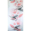 A white cotton scarf with pink designs and fantail birds