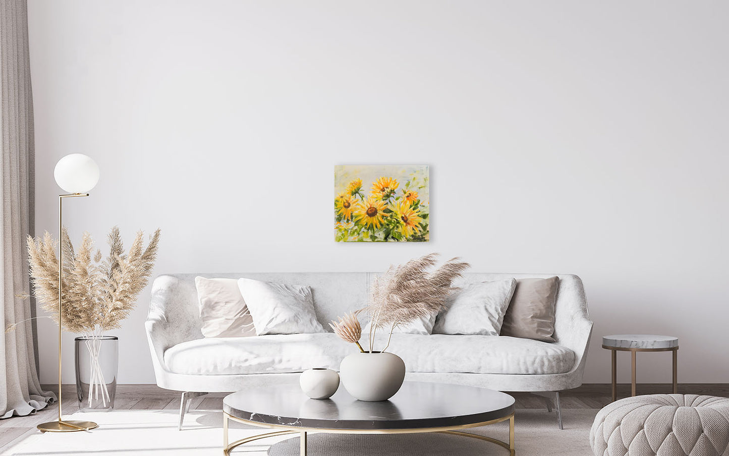 Modern living room with a white sofa, coffee table, and decorative elements.