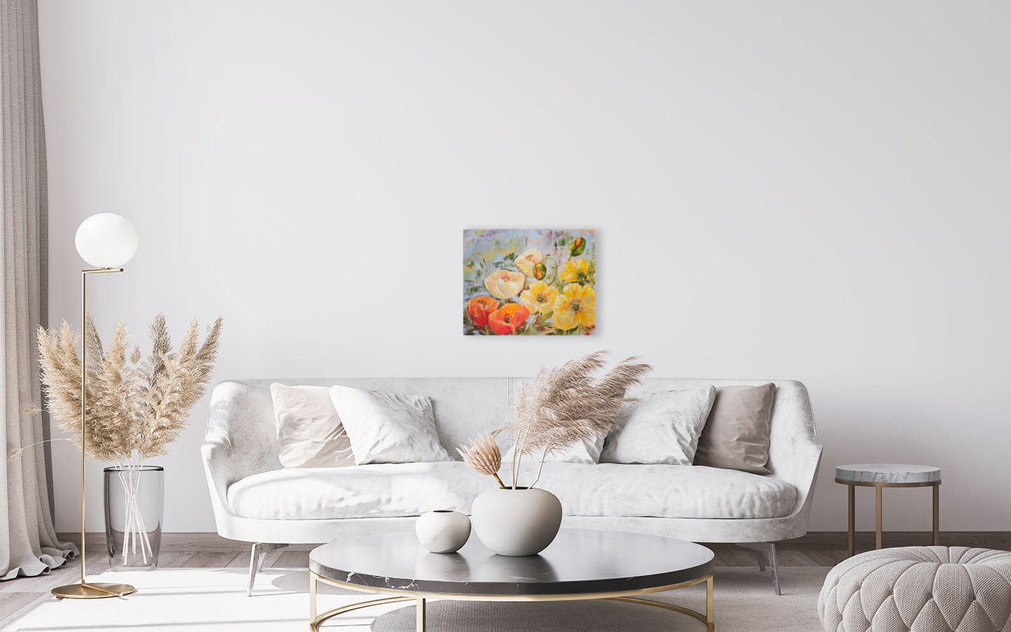 Modern living room with a white sofa, coffee table, and decorative elements. with a poppy artwork on the wall.