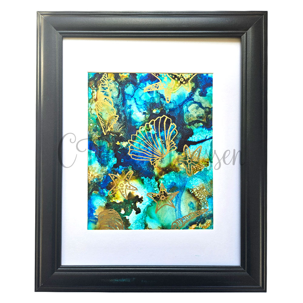 Framed artwork with gold sea-themed designs on a blue and green abstract background