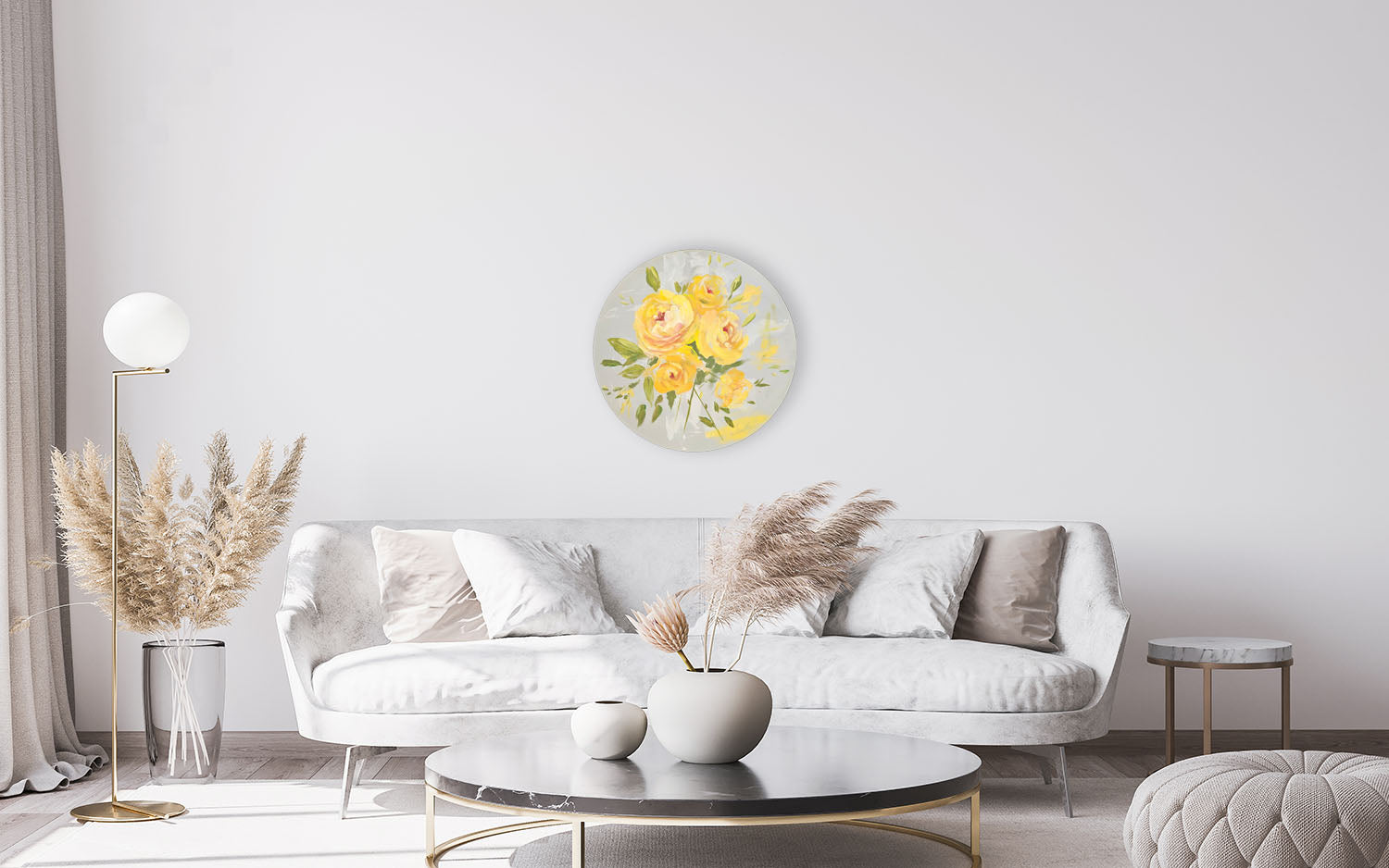 Modern living room with a white sofa, round coffee table, and decorative wall art.