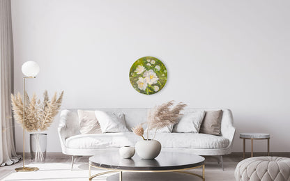 Modern living room with a white sofa, round coffee table, and decorative wall art.