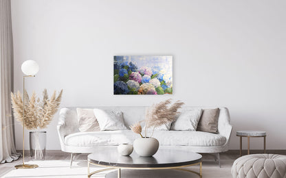 Modern living room with a white sofa, coffee table, and decorative elements Showcasing christina maassen art original artworks.